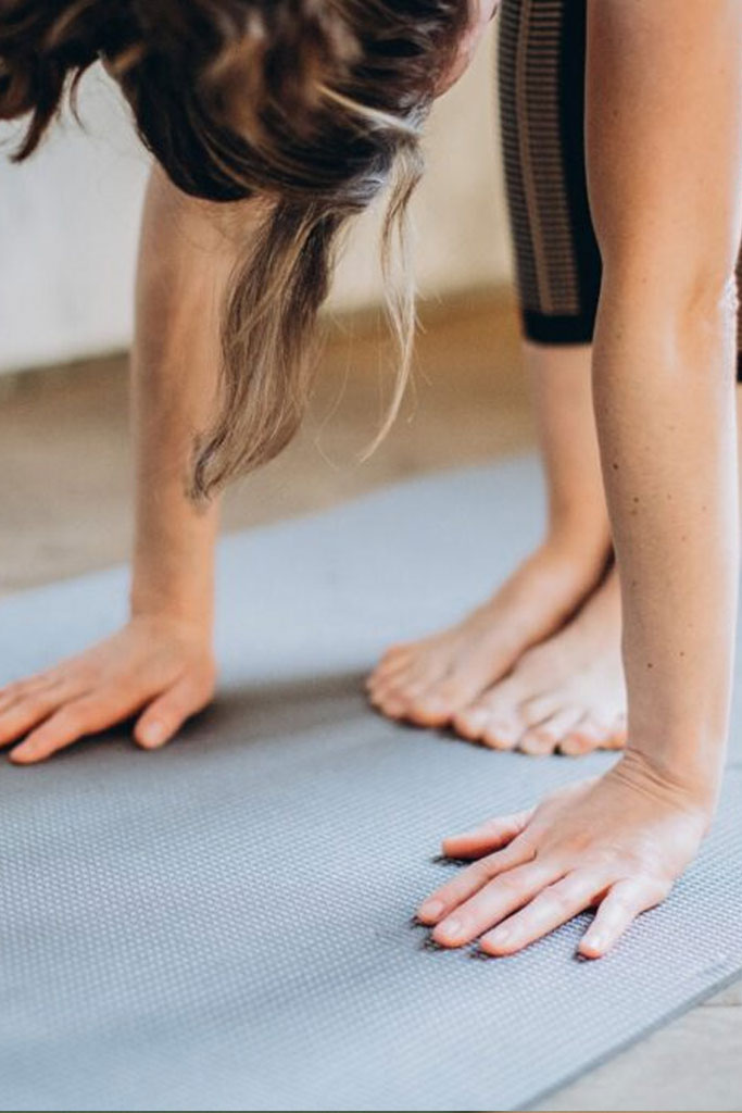 woman doing yoga on a mat