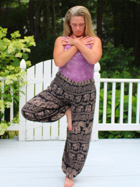 Photo of Heather doing yoga on a deck