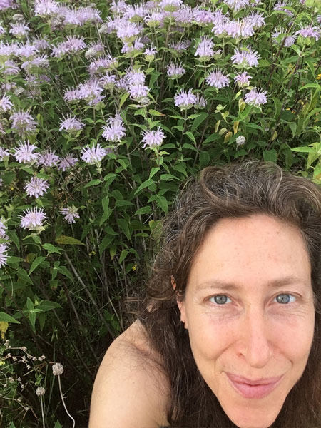 headshot of Rachel Orman in a field of purple flowers